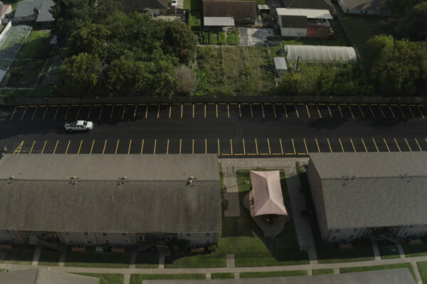 View from the air of a newly paved parking lot with parking space markings created by AAA Paving.