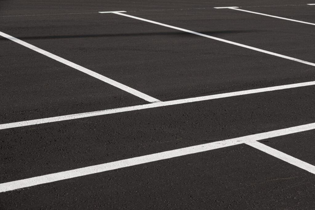 Close-up,Of,Freshly,Marked,Parking,Lot,With,White,Lines